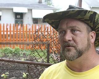 William D. Lewis\The Vindicator
William D. Lewis\The Vindicator
Mason Carratt stands near his garden on Hillman in Youngstown 6/10/13 He has cleaned up a vacant trash filled lot and planted a garden where he plans to offer produce to those in need.