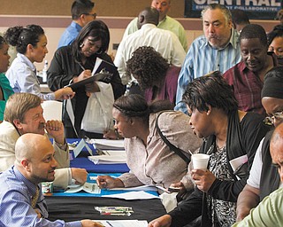 Job seekers inquire for positions at the 12th annual Mission career fair in the skid-row area of Los Angeles. The Labor Department reported Tuesday that the number of people who quit their jobs rose in April, as did hiring.