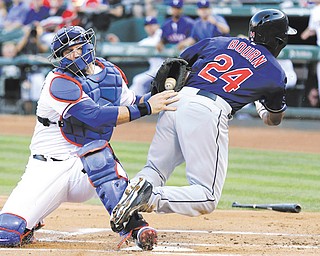 Rangers catcher A.J. Pierzynski, left, tags out Indians baserunner Michael Bourn at home plate during Cleveland’s win on Wednesday in Arlington, Texas.
