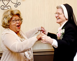 William D. Lewis\The Vindicator Sister Jerome Corcoran dances with Sophia Brooks during a June 13, 2013 event at A La Cart Caterning in Canfield. Brooks taught preschool at the Mill Creek Childrens Center. .William D. Lewis\The Vindicator.