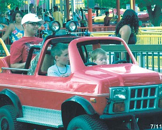 Jason Hnat of Boardman is the backseat driver in this picture with his sons, Caleb and Colin, steering the ride at Cedar Point in Sandusky.