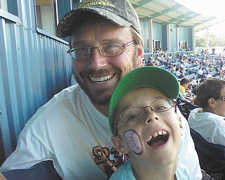 Mark Keil and his son Nikolaus, 9, share a fun day at a Scrappers game last July. They live in Struthers.