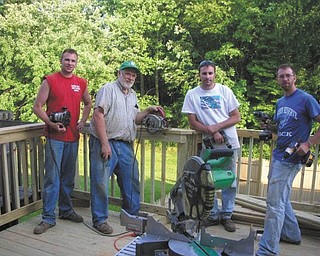 Bob Day of Berlin Center (second from left) took his sons (from left) Adam and Ryan, both of Austintown, to his son Eric's (right) home in Baltimore to build a new deck.