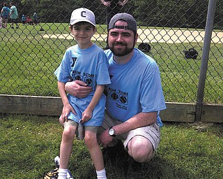 Nathan Richley, 6, is with his coach and father, Joseph Richley of Poland. Nathan plays baseball for the YMCA baseball league.