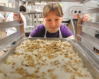 Robyn Mowrey, 14, of Canfield, places this dessert into a tray before it’s placed in the oven for baking. Robyn participated in Mahoning County Career and Technical Center’s Career Camp for sixth- through eighth-graders.
