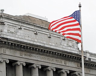 An American flag waves in the breeze in front of the Mahoning County Courthouse on Market Street in downtown Youngstown.