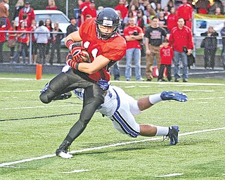 Canfield’s Jake Dawson (11) breaks away from Poland defender Adam Wollet during an All-American Conference game last fall. With the addition of a seventh division, Canfield and Poland also will be together in the new Division III.