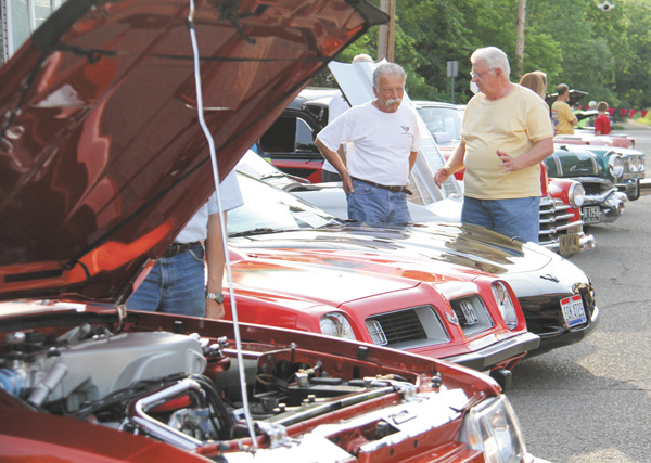 Joe Carbon of Poland, left, talks about his 2002 Corvette with Mike Yajich during Cruisin’ the River, which is sponsored by the Lowellville Business Association. The event takes place from 6 to 9 p.m. Mondays, or 5 to 8 p.m. Mondays on and after Labor Day.