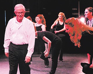 Tony Romeo walks off stage at Canfield High School Thursday night while his dancers give him a bow during his final dance recital after 58 years of teaching dance in the Valley.