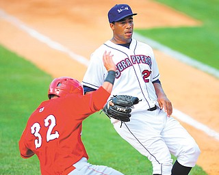 Auburn baserunner Erick Fernandez slides into home plate while Scrappers pitcher Harold Guerrero attempts
to cover home after throwing a wild pitch in the top of the sixth inning of Sunday’s New York-Penn League game at Eastwood Field. The Scrappers won 3-1.