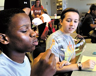 Syied Bowers, 13, an eighth-grader in Chaney’s STEM program, was able to blow a bubble onto a piece of construction paper that lasted long enough to leave a mark. He was then able to measure its circumference. Twenty-six sixth- through eighth-graders signed up for the program this week at YSU, after 26 others participated last week.