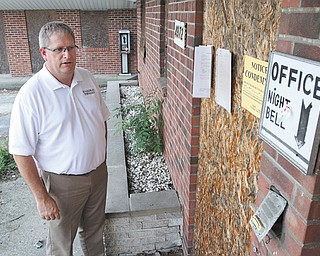 Boardman Township trustee Brad Calhoun gets a close look at the front entrance of the Terrace Motel, an eyesore on Market Street in the township that is finally coming down in July.