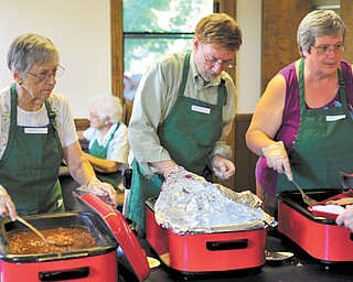 Friends of The Banquet in Salem are ready to serve the Monday night meal at Salem Memorial Building. From left are Myrtle Bailey of Winona, Wendell Satterthwait of New York and Meta Culler of Salem. About 200 meals are served every Monday.