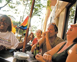 Celebrating Wednesday’s Supreme Court ruling striking down a key provision of the federal Defense of Marriage Act at the Lemon Grove in downtown Youngstown are from left, Anita Davis, Matthew Cataline, Terry Esarco and Evan Miller-Murphy. During a discussion about the decision, Miller-Murphy said, “It’s really not about gay rights. It’s about being a human. I want to go to the zoo with my wife and kids and not get stared at.”