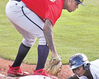Mahoning Valley’s Juan Herrera gets back to first as State College first baseman David Washington (32) tries to make the tag on pick-off attempt during a New York-Penn League game Thursday night at Eastwood Field.
