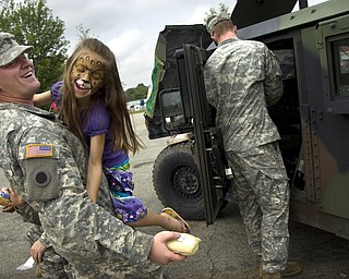 Kelli Cardinal/The Vindicator

Army Specialist Robert Pluche, from Akron, plays Sunday with his cousin Elizabeth Smith, 7, from Girard, next to an armored humvee at the Ohio Army National Guard B Co., 237th Brigade Support Battalion open house at Christy Armory in Austintown.  