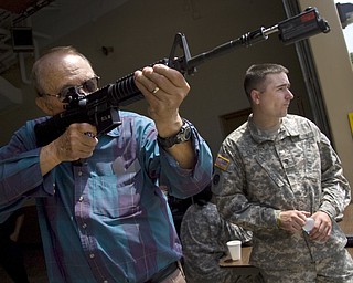 Kelli Cardinal/The Vindicator
Marty Greggo, from Austintown, practices target shooting Sunday with Army Specialist Sean Clancy, from Akron, during the Ohio Army National Guard B Co., 237th Brigade Support Battalion open house at Christy Armory in Austintown.  Greggo served with the Ohio Army National Guard from 1955-1967.
