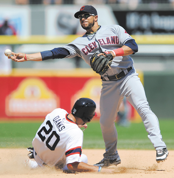 Cleveland Indians second baseman Mike Aviles, right, throws to first base after forcing out Chicago White Sox’s Jordan Danks at second base during the sixth inning of a game in Chicago on Sunday. Cleveland won 4-0.
