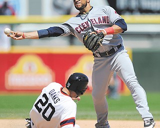 Cleveland Indians second baseman Mike Aviles, right, throws to first base after forcing out Chicago White Sox’s Jordan Danks at second base during the sixth inning of a game in Chicago on Sunday. Cleveland won 4-0.