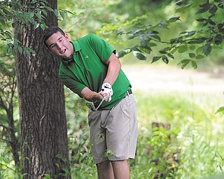 Lorenzo Sabella of Canfield chips on to the 14th green at Diamond Back Golf Course in Canfield following a drop after hitting it into the rough Tuesday during the Junior boys qualifier for the Greatest Golfer of the Valley tournament.
