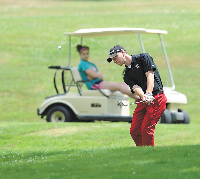 Jimmy Naples, a student at Ursuline High School, chips back onto the green after overshooting the 14th hole at Diamond Back Golf Course in Canfield during Tuesday’s Junior boys’ qualifier.
