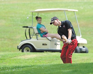 Jimmy Naples, a student at Ursuline High School, chips back onto the green after overshooting the 14th hole at Diamond Back Golf Course in Canfield during Tuesday’s Junior boys’ qualifier.
