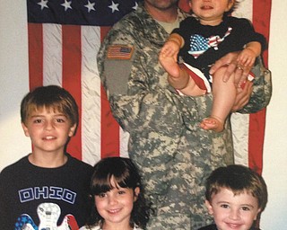 Cpl. Michael Polombi, son of Cookie and Anthony Polombi, holding a nephew, Tommy Strain. From left are Anthony Polombi, Michael's son; Gina Strain, his niece; and Colin Polombi, also Michael's son. Michael is serving in the U.S. Army and is stationed in Watertown, New York, with his wife, Jennifer (Silver) Polombi, Anthony, Colin, and Alexander, born June 2. Submitted by Cookie Polombi.