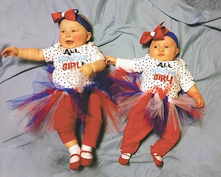 Allie Snyder of Toledo and Leigha Quiring of Medina dawn red, white and blue at a family picnic in Girard. Though the girls are technically third cousins once removed, their large, Italian family in the Youngstown area feels "a cousin's a cousin." Sent by Allie's great-grandmother, Rita Finelli.