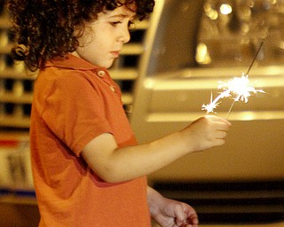 MADELYN P. HASTINGS | THE VINDICATOR
Albara Jwayyed, 3, of Katy, Texas holds a sparkler before watching the firework display shot from the Covelli Centre in downtown Youngstown on July 4, 2013.