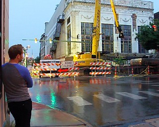 William d LEwis The Vindicator Nicholas Serra watchesas demo of the historic Paramount Theater gets underway Monday night. A parking lot will be built on hte site at Hazel and W,Federal in dowtown Y-town.