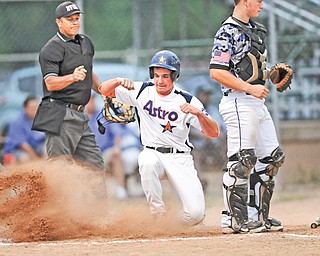 Astro Falcons baserunner Vinny Ruberto slides in behind Ohio Glaciers catcher Jake Smith to score in the first inning of Game 2 of the Little b championship Monday at Cene Park in Struthers. The Falcons led 3-0 when play was suspended by lightning in the second inning.