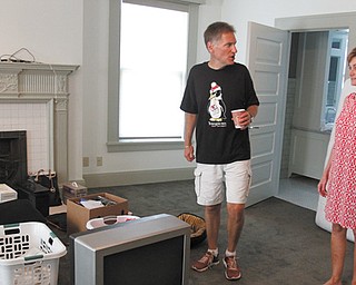 Randy and Ronda Dunn look over items to be arranged in their new home, the Pollock House, as Dunn prepares to take office as Youngstown State University’s eighth president July 15. The Dunns began moving into the historic mansion Monday, coming from Murray, Ky., where Dunn served as president of Murray State University for six years.