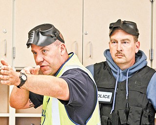 Hubbard City Police Sgt. Christopher Moffitt, left, instructs while Detective David Oaks listens during an active shooter scenario training at Hubbard Middle School.