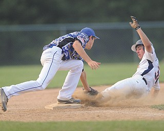 Astro Falcons baserunner Vinny Ruberto is tagged out by the Ohio Glaciers third baseman Evan Kendall. as he attempted to steal third during the bottom of the sixth inning in Game 2 of the Little b championship Tuesday at Cene Park in Struthers. The game was suspended for the second time in two days by lightning, with the Falcons leading the game at 6-4 and the series 1-0. Play resumes today at 8 p.m. on Cene 1, where Game 3 will follow, if necessary.