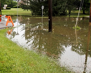 MADELYN P. HASTINGS I THE VINDICATOR
The intersection of Tioga and Ridge Rd. in Newton Falls was shut down after flooding covered the town during a storm on July 10, 2013.