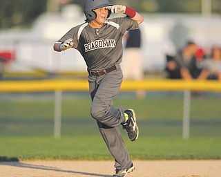 Boardman slugger Cameron Kreps salutes while trotting around the bases after hitting a two-run homer against
Austintown. Boardman won, 16-3, to earn the Little League 11-12 district title.