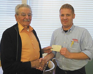 SPECIAL TO THE VINDICATOR
The Mahoning and Shenango Valleys Chapter of the Military Officers Association of America had a recent dinner meeting at the Golden Corral in Hermitage, Pa. MSVC donated to Camp Corral via the store manager. Maj. Peter Mihai, MSVC-MOAA president, above left, presents a check to Ed Wuethrich, the restaurant’s manager. Through Golden Corral Corp.’s sponsorship, Camp Corral provides free summer camp for children 8 to 15 in military families. Children in a family of a wounded, disabled or fallen service member receive priority. For information visit www.campcorral.org.