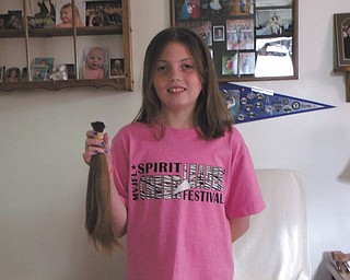 Haylie Rotz, 12, holding her recently shorn locks, donated her hair to Locks of Love on June 15 for the sixth time. She began donating when she was 2. Haylie is the daughter of John and Lisa Rotz of Lowellville, and the granddaughter of William and Julie Brozman and Stephen and Lucille Gocala. Locks of Love helps disadvantaged children 18 and under with medical conditions by providing hairpieces that help restore their self-esteem and confidence. Hair donation guidelines are available at www.locksoflove.org.