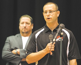 D.J. Aldish, school resource officer for the Struthers City School District, speaks during Tuesday’s Struthers Board of Education meeting about a policy to test student athletes in grades seven through 12 for drugs. At left is Superintendent Joseph Nohra.