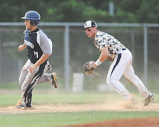 Baird Brothers’ Alec Hammond, left, rounds third base to score a run in top of the third inning Tuesday night in a Connie Mack State Tournament at Cene park. Kuboff & Associates third baseman Cam Balego is at right.