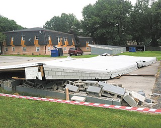 A woman and two children were taken for treatment to St. Elizabeth Health Center, Youngstown, after this carport collapsed on them Wednesday morning at 110 Lemans Drive in Boardman. Police said a man, believed to be related to the victims, accidentally ran into a support beam with his vehicle. Township police are investigating.