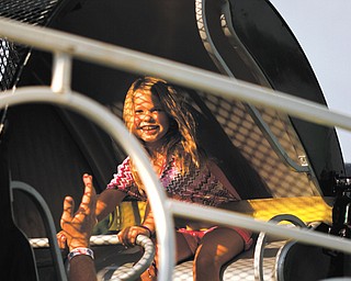 Jadalyn Rose Hollobaugh, 5, rides a carnival ride at the Mount Carmel Society Festival in Lowellville on Wednesday. The festival, now in its 118th year, opened Wednesday and will run through Saturday.