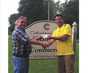 Jack Guy, left, presented a check for $2,205 to Brent Burns for the 50-50 drawing Burns won at Columbiana’s 4th of July Community Celebration at Firestone Park. Guy is the director of the board 
of the Columbiana Area Chamber of Commerce and the chairman of the committee.

SPECIAL TO THE VINDICATOR