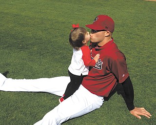 In this family photo, Justin Thomas receives a kiss from his daughter  Ella. Thomas, a fourth-round draft pick by the Seattle Mariners in 2004 out of Youngstown State, just inked a deal to play pro ball in the Japanese Baseball League with the Nippon-Ham Fighters.