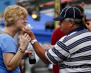 MADELYN P. HASTINGS | THE VINDICATOR

Fred Hunsinger of Canfield helps his wife, Sue, by wiping barbecue sauce off her face at the Eastwood Rib Fest in Niles on Saturday, July 20. The event runs through Sunday.
