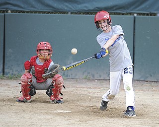 Mill Creek batter #23 Patrick Donofrid swings at a pitch during practice Sunday night. Catcher #18 Christian Myers pictured behind.