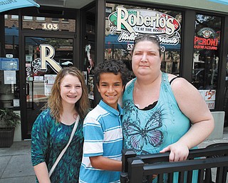 Helen Bond, a single mother of two, recently was diagnosed with acute renal failure. Family members and friends are planning a benefit dinner for Aug. 11 at the Holy Rosary Educational Center in Lowellville. Bond is shown above with her children, Alyssa Guerrieri, 14, and Dylan Bond, 11, in front of her uncle’s downtown Youngstown restaurant, where Bond used to work.