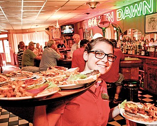 Golden Dawn server Anna Booth delivers a tray of Jumbo Burgers to the Burger Guyz.