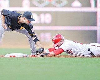 Pittsburgh Pirates second baseman Neil Walker, left, tags out Washington Nationals’ Bryce Harper as he tried to steal second base during the first inning of a game Tuesday in Washington.
