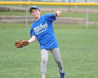 Mill Creek player Evan Kenneally #20 throws a ball while playing catch during practice Monday morning.